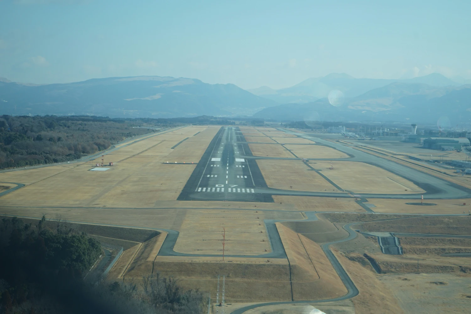 Aerial view of an airport runway framed by mountains — legal checklist for investing in Ukrainian airport infrastructure
