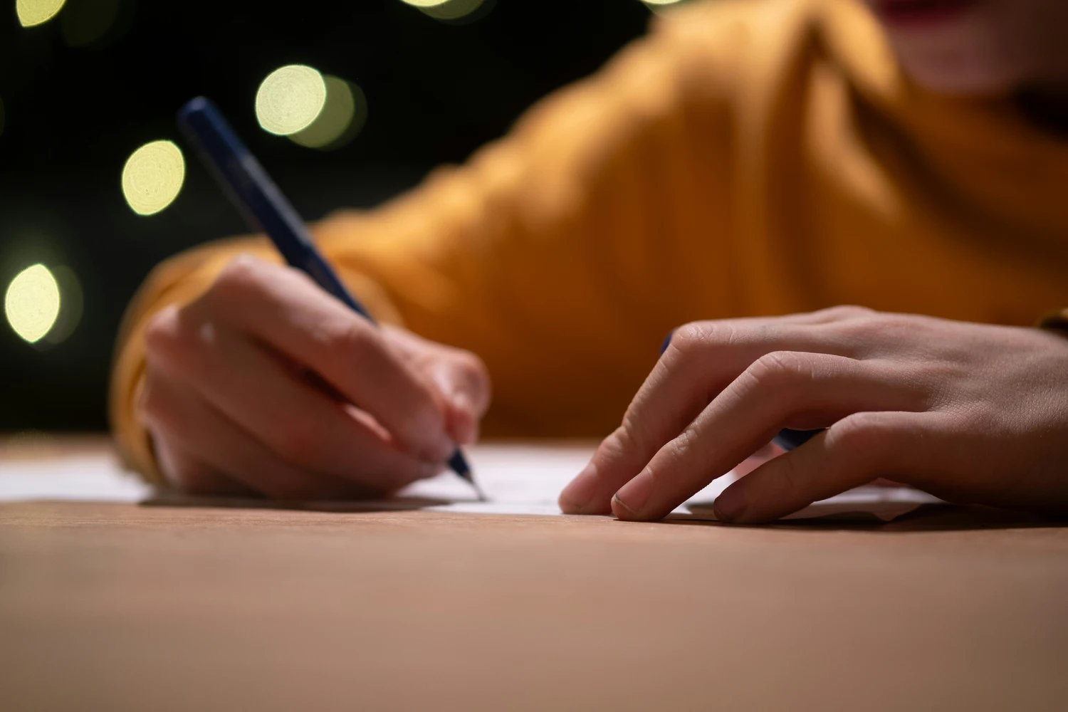 Close-up of a professional writing on a document at a desk — instructing a Ukrainian law expert witness