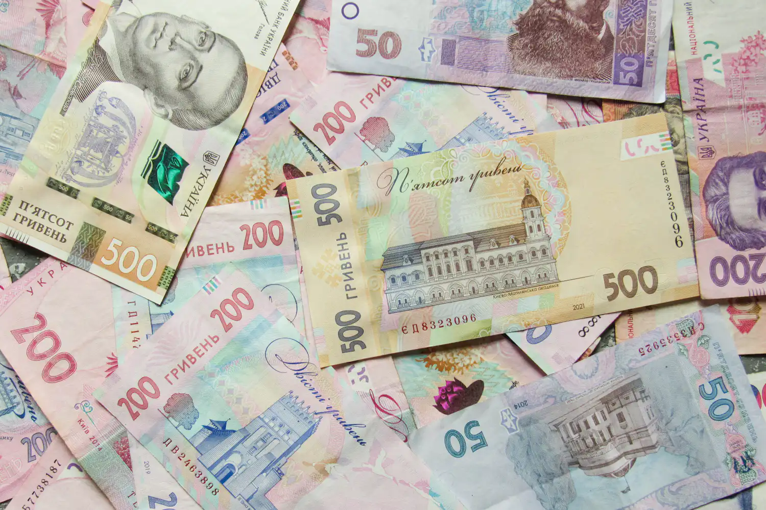 Scattered Ukrainian hryvnia banknotes of 50, 200 and 500 hryvnias